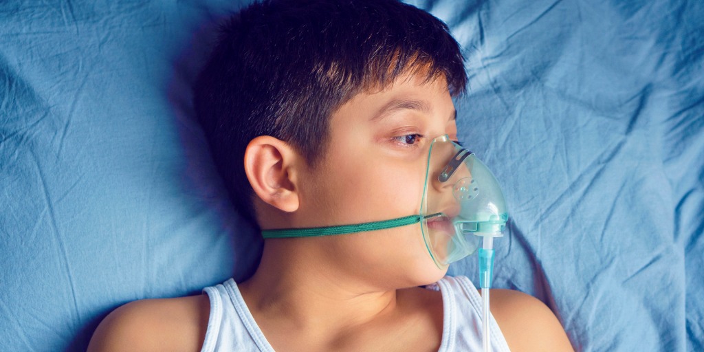 photo of doctor examining young boy